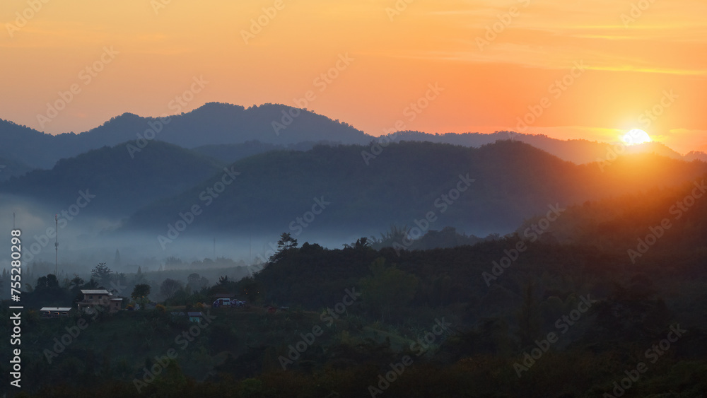 Golden Mystical Sun Rise and Misty Landscape and Village