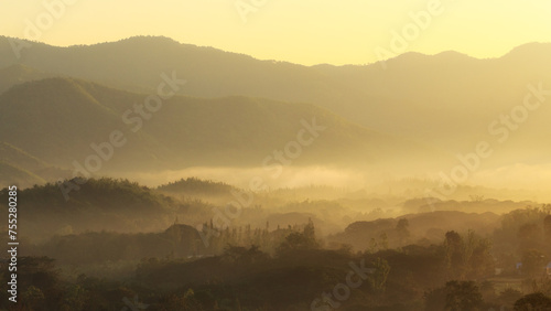Golden Mystical Sun Rise and Misty Landscape © Jakapan