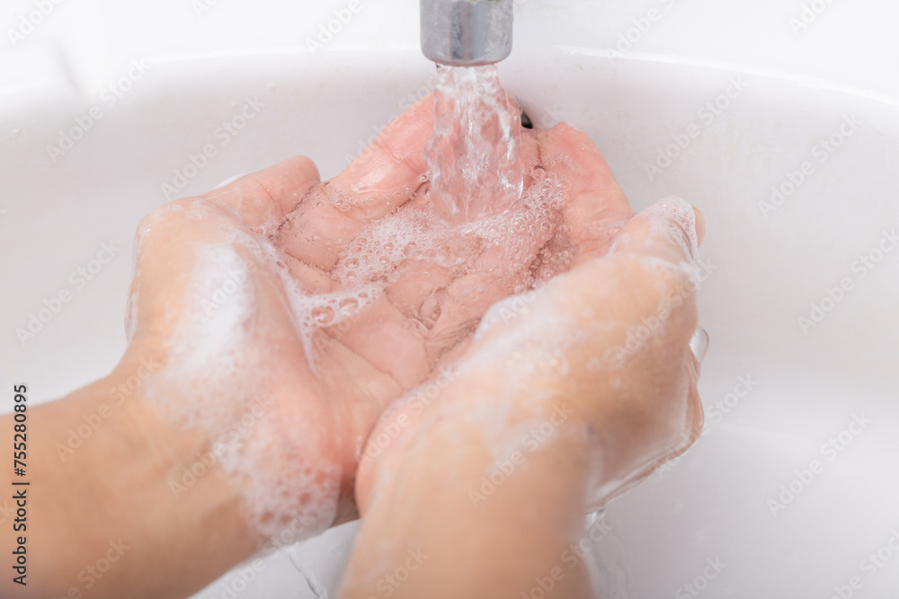 Fototapeta premium Washing thoroughly your hands with water and soap
