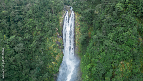 huge waterfall in the middle of the jungle of Costa Rica surrounded by vegetation in the Barbilla National Park in indigenous territory