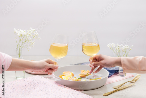 Couple having clinking glasses with tasty wine romantic dinner.