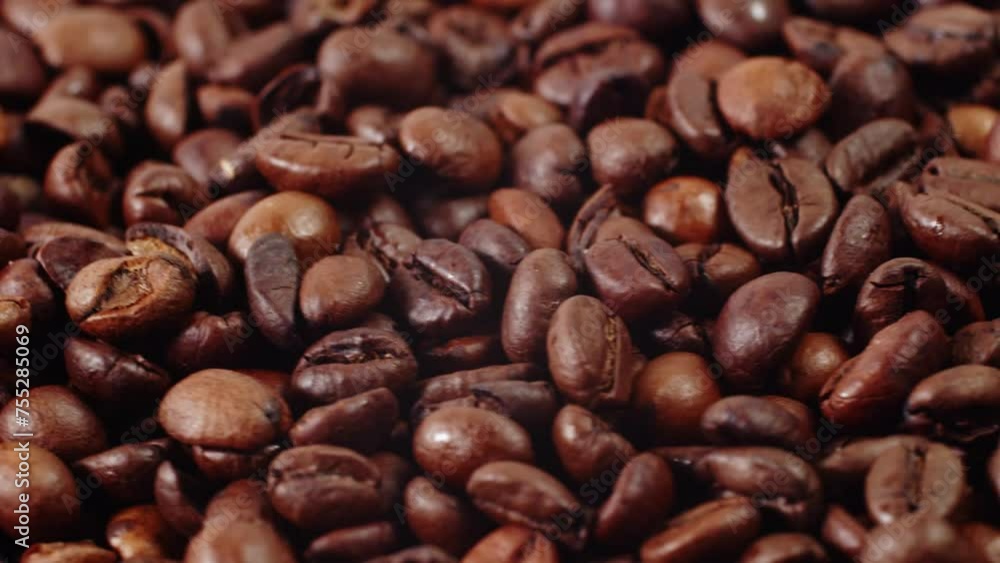 Textured background of freshly roasted coffee beans. Roasted coffee beans rotate, coffee beans background. Coffee beans background. Textured background of freshly roasted coffee beans. Roasted coffee beans rotate, coffee beans background. Coffee beans background.