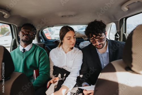 Schilderij op canvas A group of professionals in business attire sharing a ride in a car during a bus
