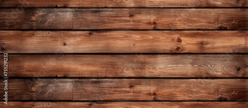 A detailed closeup of a brown hardwood wall constructed with rectangular wooden planks. The varying tints and shades create a beautiful pattern, perfect for building material or flooring