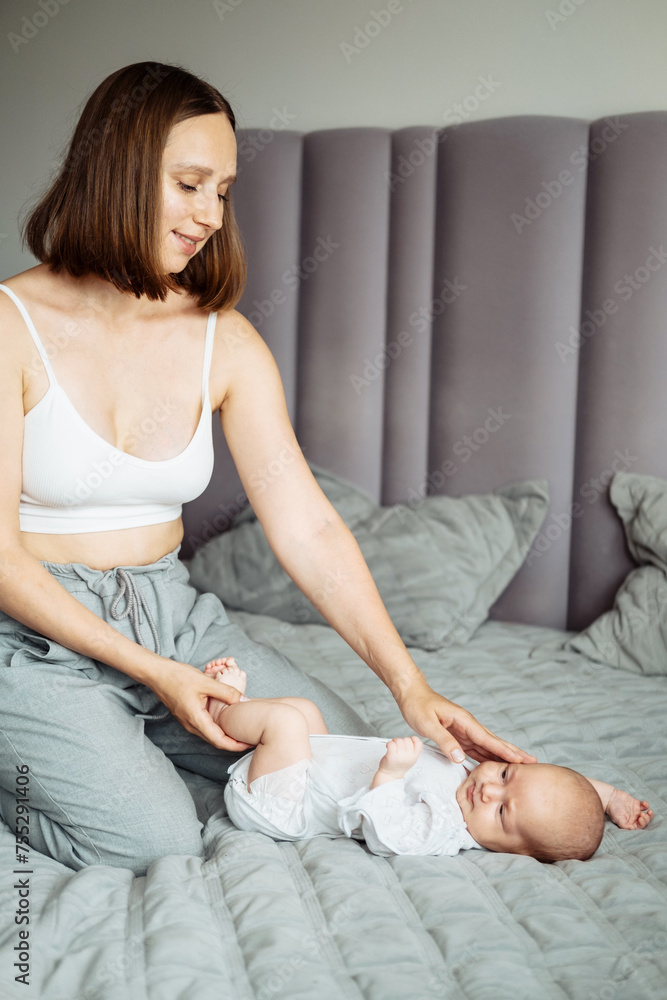Home portrait of a newborn baby with mother on the bed. Home portrait of a newborn baby with mother on the bed.