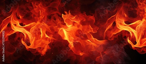 This close-up shot captures the intensity of red and yellow flames in a blazing fire. The flames are flickering and dancing, showcasing their vibrant colors and intricate textures.