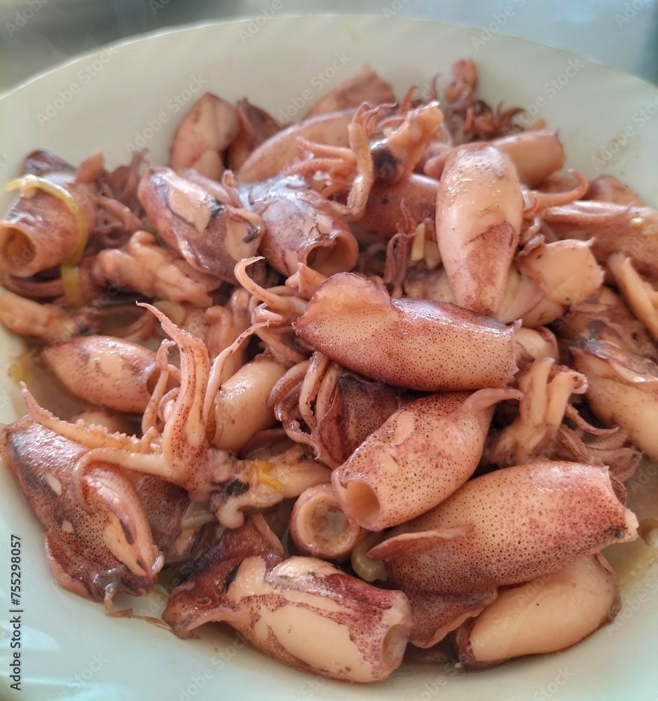 Delicious oyster sauce squid, restaurant-style home cooking. Indonesian seafood. Close-up.
Delicious oyster sauce squid, restaurant-style home cooking. Indonesian seafood. Close-up.
