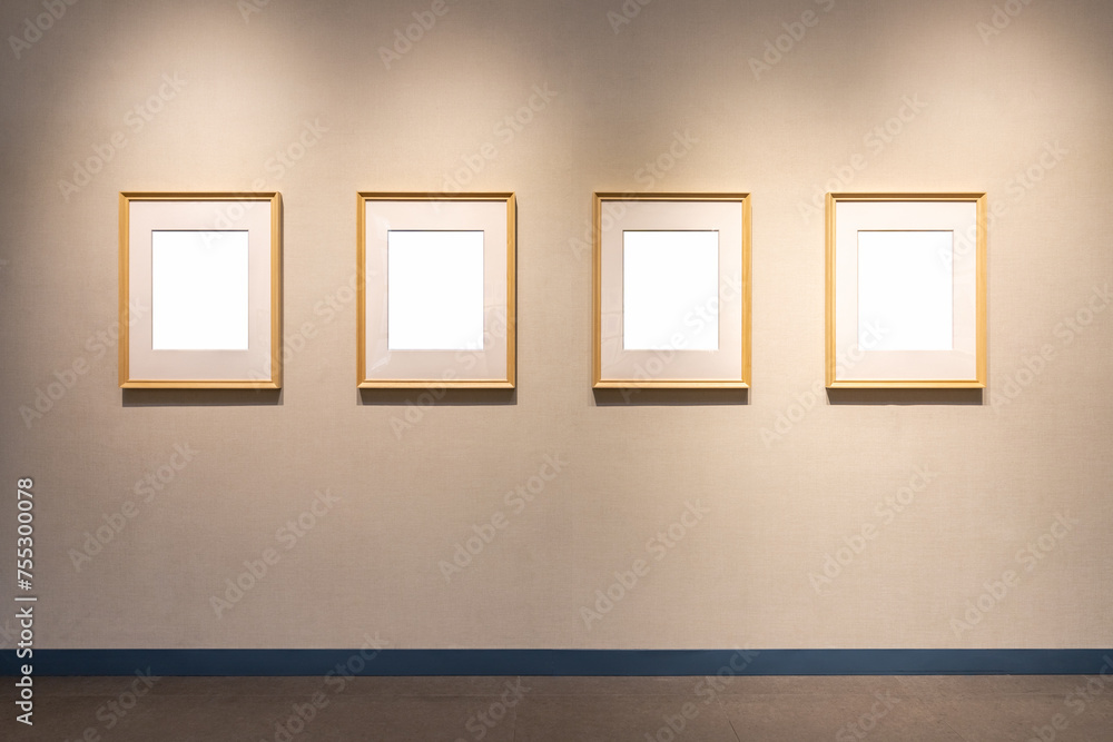 four blank wooden picture frames on wall four blank wooden picture frames on wall