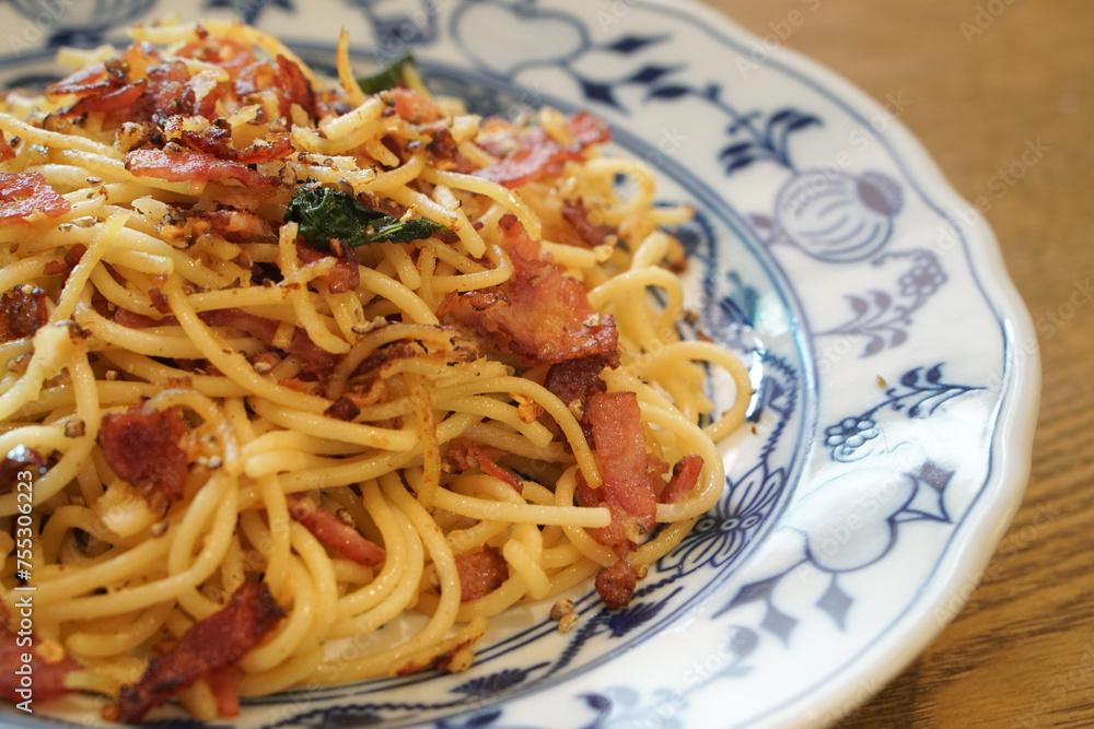 Dried chilli garlic bacon pasta on vintage plate