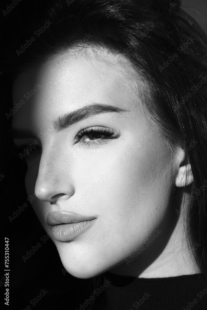 Fototapeta premium Surrealist portrait of young lady with art makeup. Black and white photography of beautiful women with smoky-eyes eyeshadows