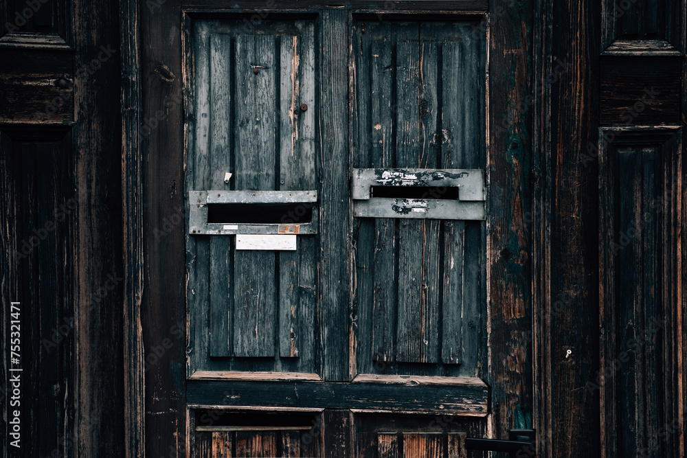 Old dark wooden door close-up of mail box. Ancient architecture and texture of the city street Old dark wooden door close-up of mail box. Ancient architecture and texture of the city street