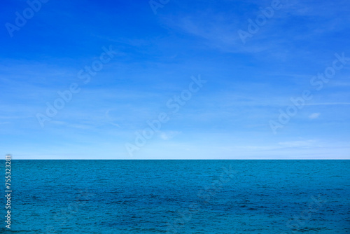 background for summer vacation concept. Nature of the beach and sea, summer with sunlight, sandy beach The sparkling sea water contrasts with the blue sky 