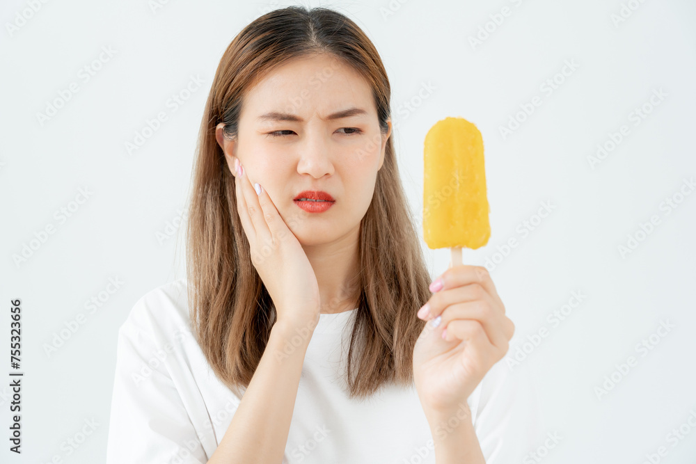 Asian woman feel sensitive teeth after eating ice cream, female suffer tooth, decay problems, dental care, tooth extraction, decay problem, bad breath, Gingival Recession, Oral Hygiene instruction Asian woman feel sensitive teeth after eating ice cream, female suffer tooth, decay problems, dental care, tooth extraction, decay problem, bad breath, Gingival Recession, Oral Hygiene instruction