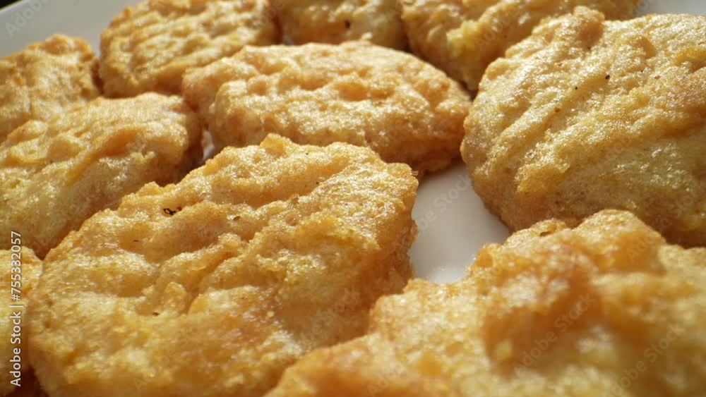 Chicken nuggets are bite-sized pieces of chicken meat that are breaded and deep-fried until crispy on the outside and tender on the inside. They are popular as a convenient and tasty snack. 4K UHD.
Chicken nuggets are bite-sized pieces of chicken meat that are breaded and deep-fried until crispy on the outside and tender on the inside. They are popular as a convenient and tasty snack. 4K UHD.