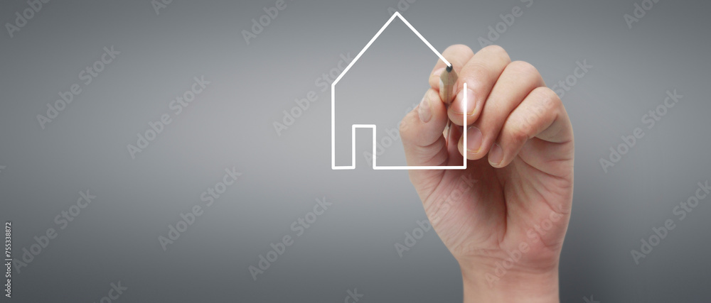 Male hand drawing house in whiteboard Male hand drawing house in whiteboard