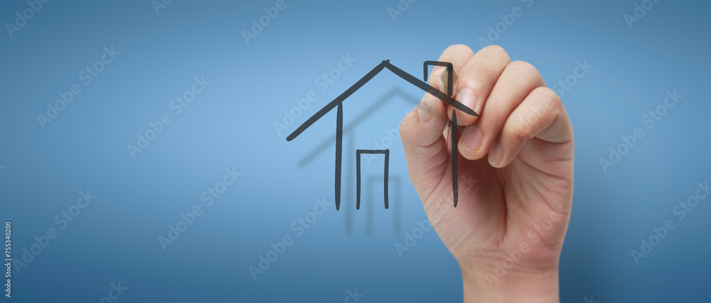 Male hand drawing house in whiteboard Male hand drawing house in whiteboard