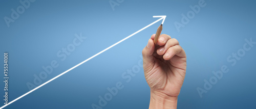 Male hand drawing graph chart showing business profit