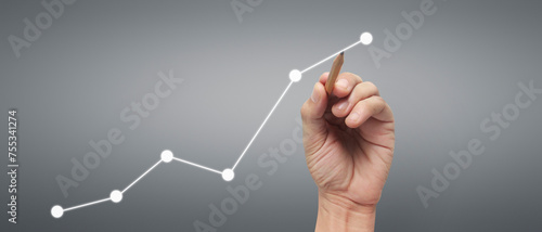 Male hand drawing graph chart showing business profit