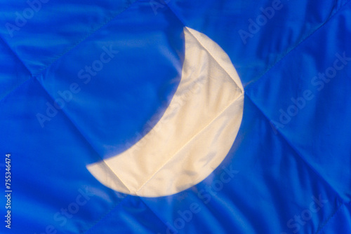 Crescent moonlight on blanket at night in bedroom, background. Conceptual background for products with melatonin, cannabis oil to relax and improve the quality of sleep at night while you sleep