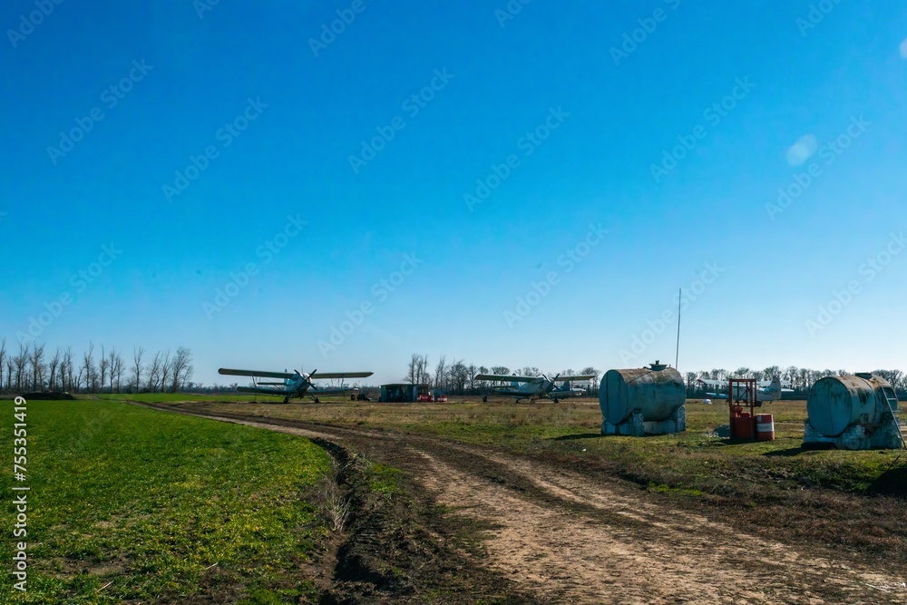field rural airfield of agricultural aviation with a pair of biplanes on a sunny day in early spring field rural airfield of agricultural aviation with a pair of biplanes on a sunny day in early spring