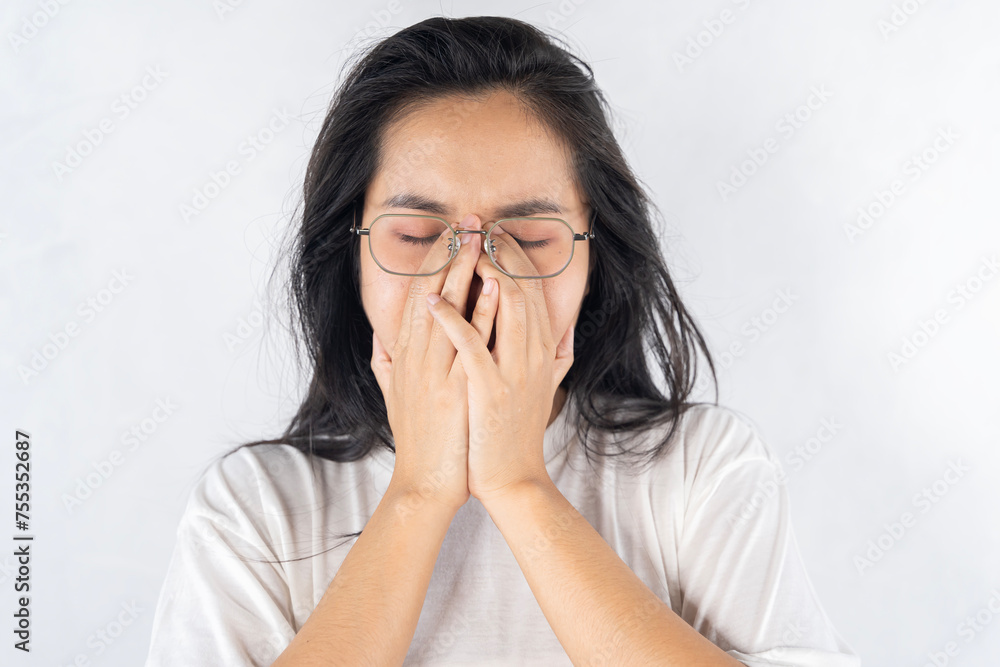 Young woman rubs her eyes after using glasses. Eye pain or fatigue concept. Young woman rubs her eyes after using glasses. Eye pain or fatigue concept.