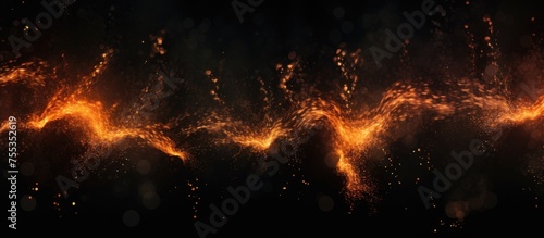 This image shows glowing orange and yellow lights against a dark background, resembling fire embers or sparks. The lights create an abstract and mesmerizing pattern.