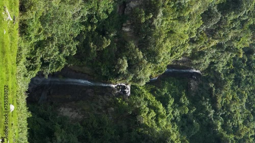 Vertical clip of a beautiful large waterfall in the neighborhood of Puichig, Mejia canton, province of Pichincha, Ecuador.