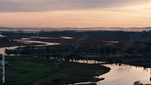 Drone aerial view of a highway heading in and out of Napa, California at sunset photo