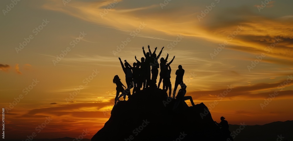 Team Celebrates Accomplishment on Mountain Peak at Sunset