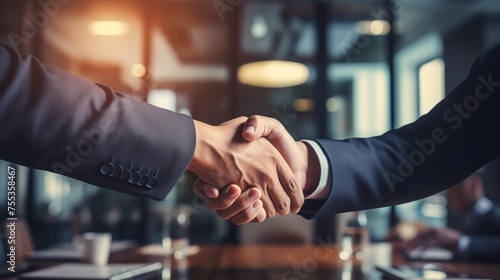  close-up view of two businessmen in business attire shaking hands during a meeting to seal an important agreement