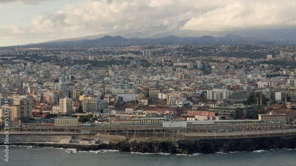 Catania City, Sicily with Mt Etna in background, drone establishing shot warm afternoon light Catania City, Sicily with Mt Etna in background, drone establishing shot warm afternoon light