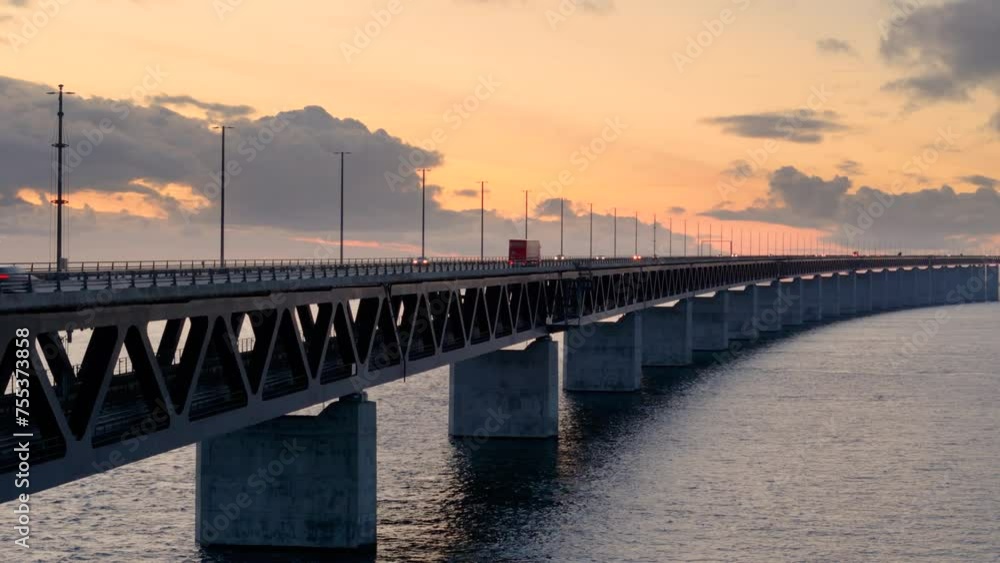 Vibrant sunset sky with traffic moving over iconic Oresund bridge. Aerial riser Vibrant sunset sky with traffic moving over iconic Oresund bridge. Aerial riser