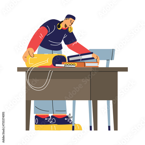 A boy student packs books into a backpack, celebrating the end of his college classes.