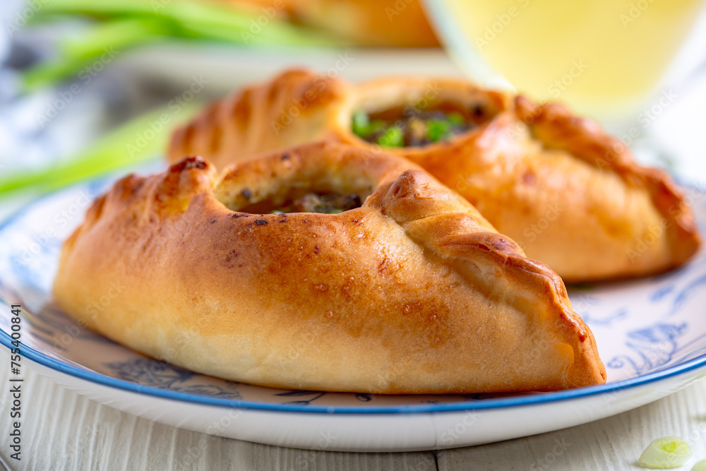 Two open pies with spicy meat filling. Two open pies with spicy meat filling.