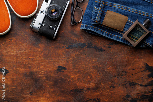 Men's Clothing on wooden Background: Jeans, Sneakers, Eyeglasses