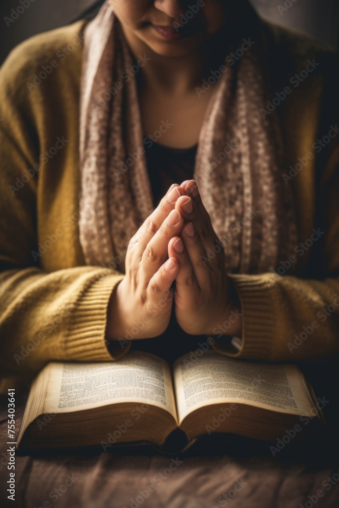 A woman sitting on a bed and praying. Suitable for religious and spiritual concepts A woman sitting on a bed and praying. Suitable for religious and spiritual concepts