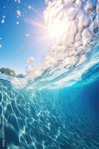 Fototapeta Naklejka Na Ścianę i Meble -  Surfer catching a wave with sunlight shining through the water. Suitable for sports and outdoor activities promotions