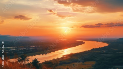 Beautiful sunset over a serene river and majestic mountains. Perfect for nature and landscape backgrounds