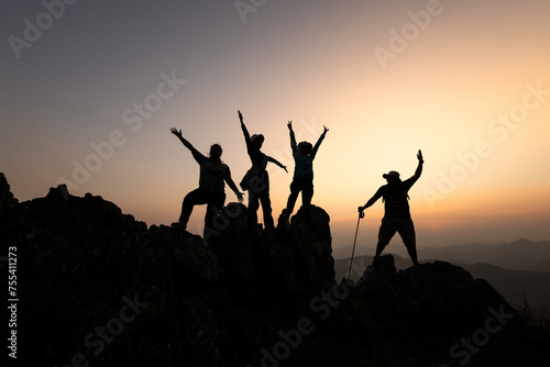 Silhouettes of a group of successful climbers on the top of a mountain. Successfully achieving your goal. Success Business Leadership, Successful person has achieving. teamwork.