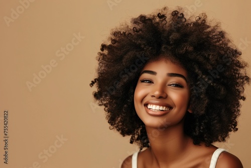 Radiant African Woman Smiling Against Beige Background
