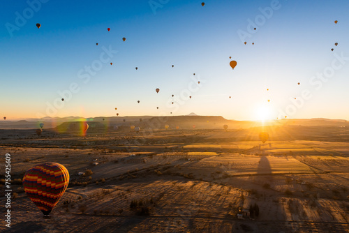 Colorful hot air balloons over the hills at sunrise in Cappadocia, Turkey.