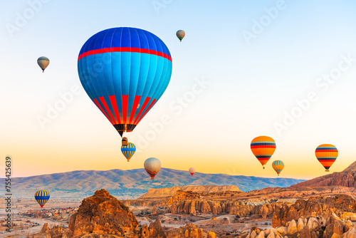 Colorful hot air balloons over the mountains in Cappadocia, Turkey.