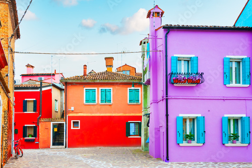 Colorful architecture in Burano island, Venice, Italy. Lavender and red painted houses.