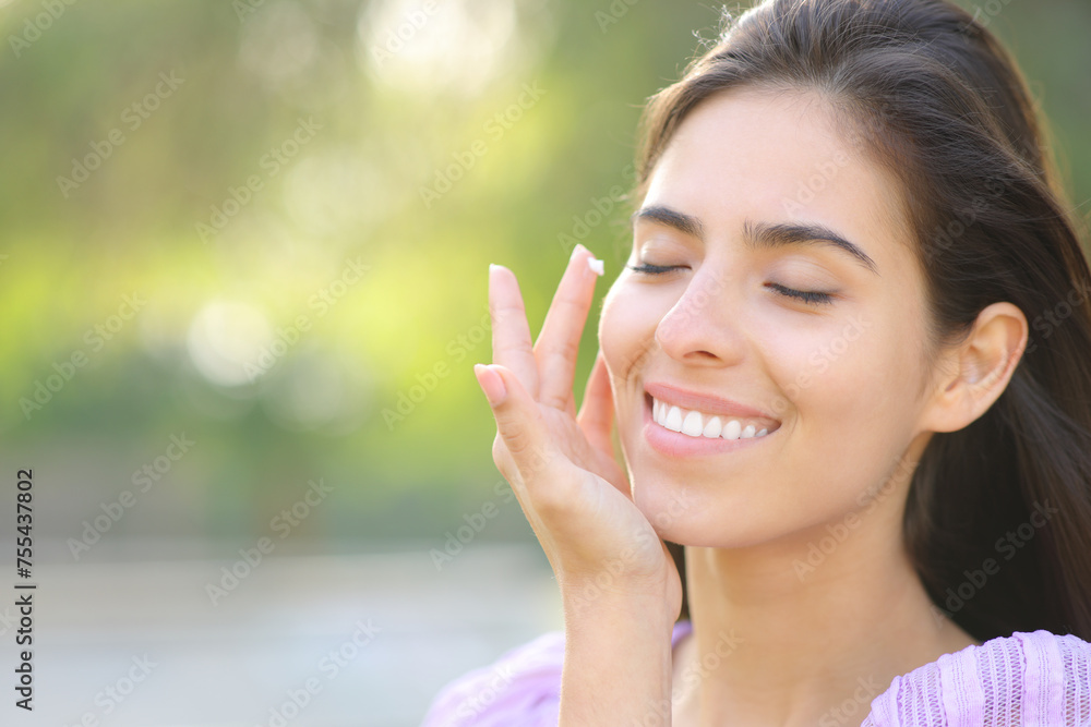 Beauty woman applying moisturizer cream on face Beauty woman applying moisturizer cream on face