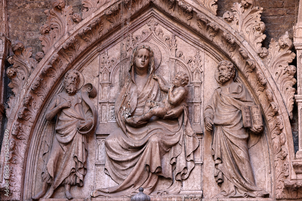 Bas-relief of the Virgin Mary with Jesus on the wall of a house in the San Marco district of Venice. Italy