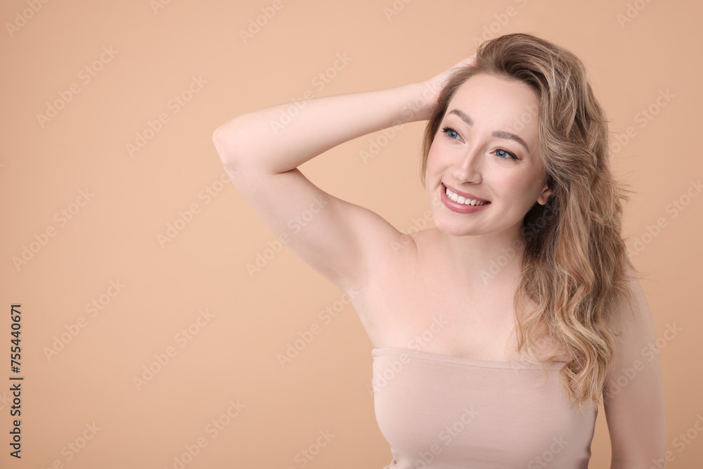 Portrait of smiling woman on beige background. Space for text Portrait of smiling woman on beige background. Space for text