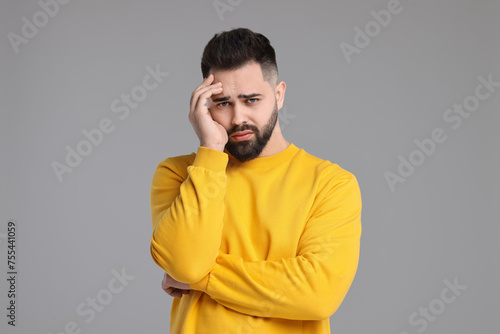 Portrait of sad man on light grey background