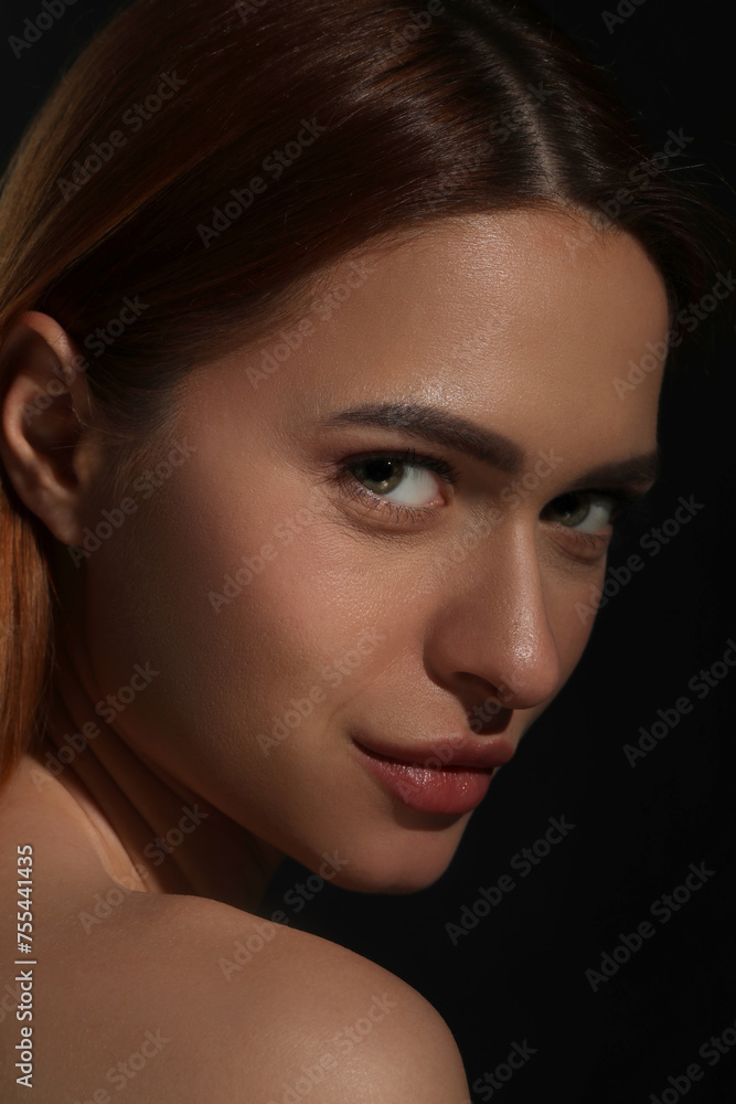 Fototapeta premium Evil eye. Young woman with scary eyes on black background