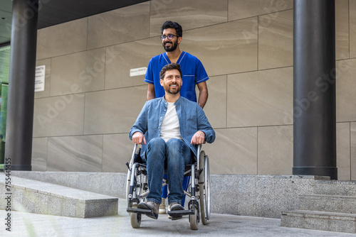 Male nurse in a blue doctors overall with a wheelchair