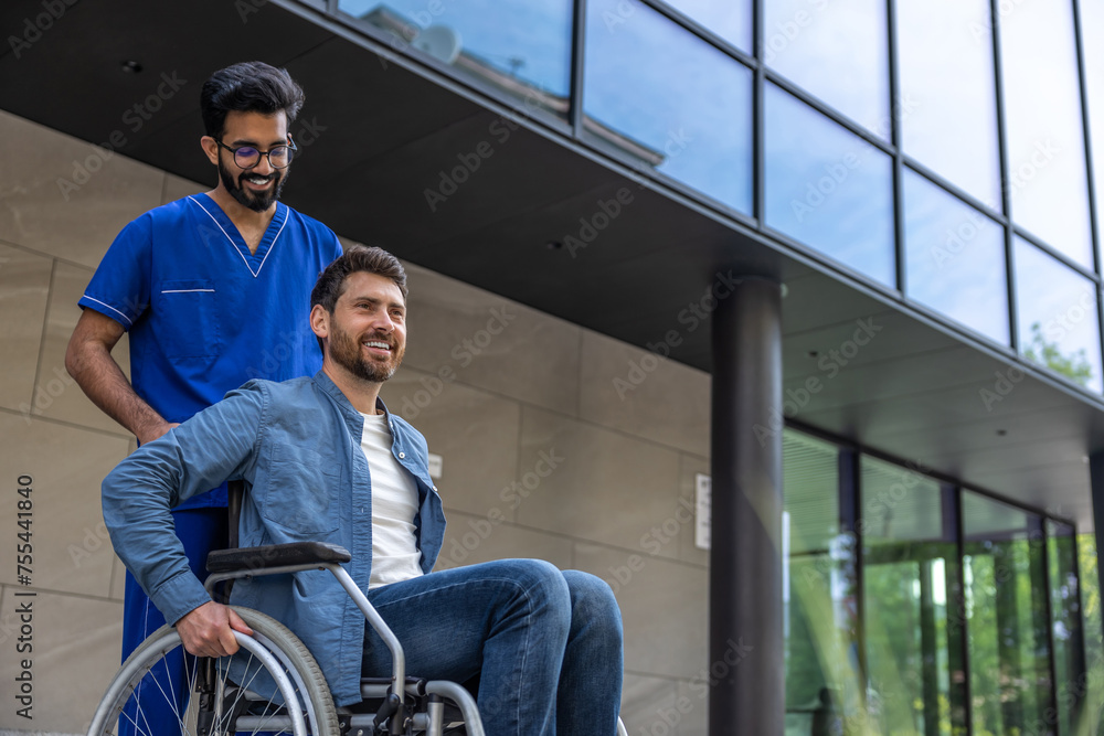 Male nurse in a blue doctors overall with a wheelchair